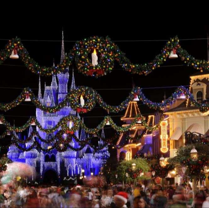 christmas decorations strung across street and disney castle in icicle lights