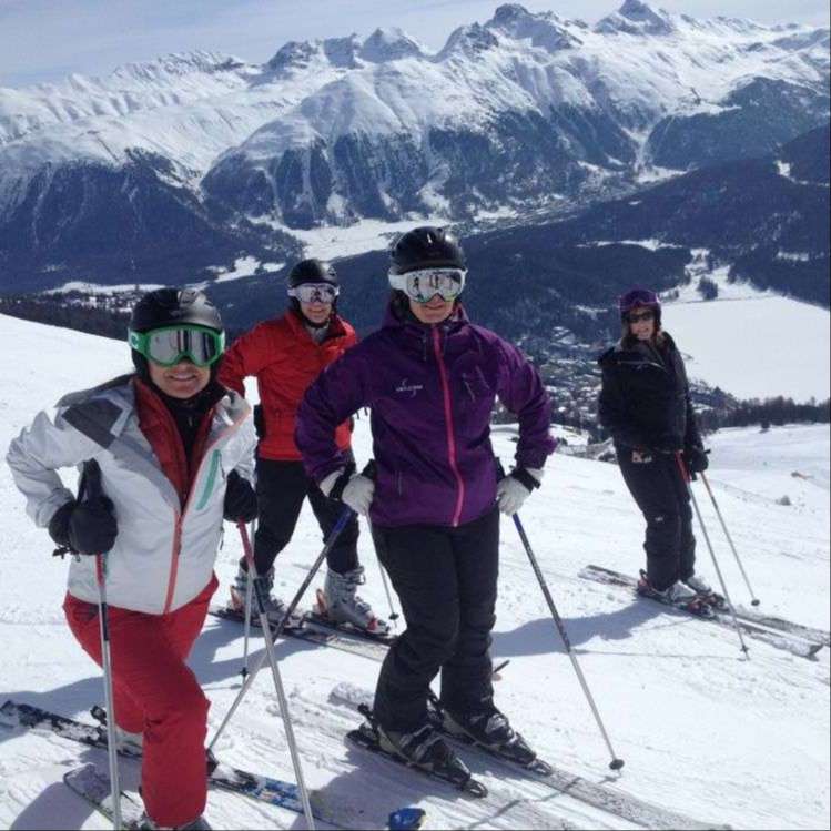 skiers in winter clothing on white mountain top