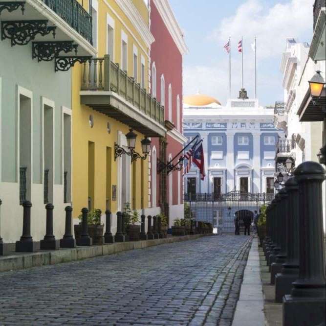 brick street, two story buildings in bright sea coast colors of blue, yellow, red and white